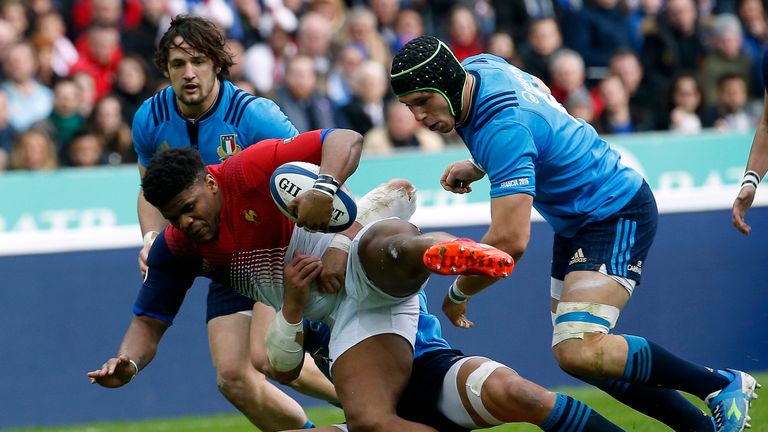 France's centre Jonathan Danty (L) is tackled  during the Six Nations international rugby union match between France and Italy