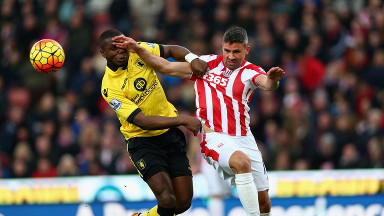 Jonathan Walters of Stoke City and Jores Okore of Aston Villa compete for the ball