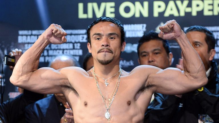 Juan Manuel Marquez poses on the scale during the official weigh-in for his bout against WBO welterweight champion Timot