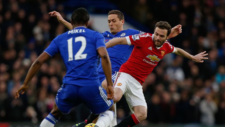 Juan Mata (R) vies with Nemanja Matic