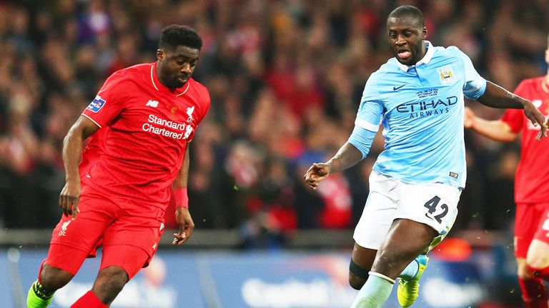 Liverpool defender Kolo Toure challenges brother Yaya Toure of Manchester City