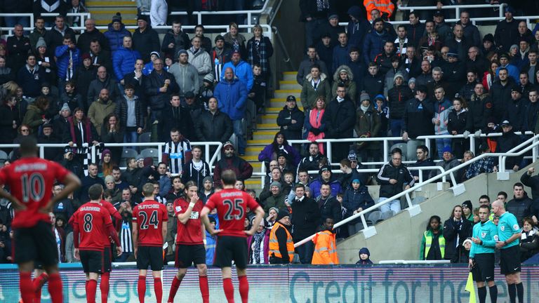 Referee Lee Mason (right) talks to his assistant about Cheick Tiote's disallowed goal in the first half