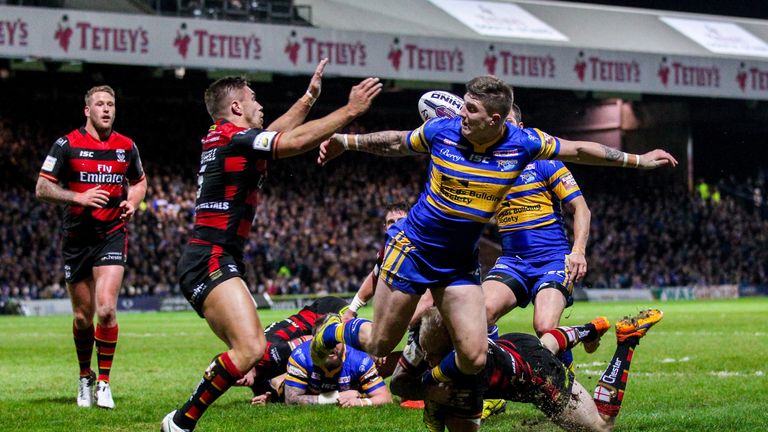 Leeds' Liam Sutcliffe loses the ball after a tackle from Warrington's Rhys Evans.