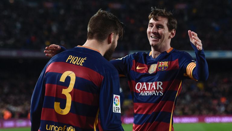 Barcelona's Gerard Pique (L) celebrates a goal with Lionel Messi 