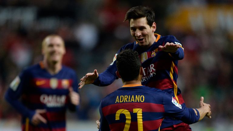 Lionel Messi celebrates with Adriano