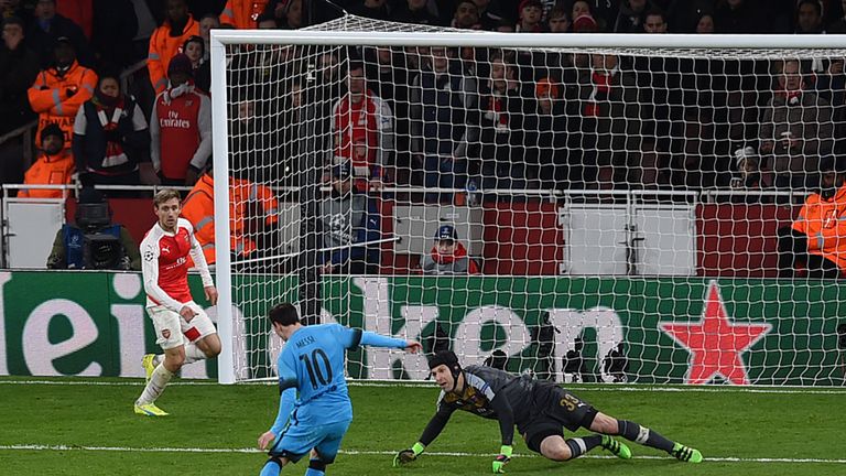 Lionel Messi shoots past Petr Cech to score the first goal in the Barcelona's 2-0 win at the Emirates