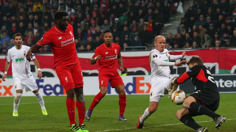Tobias Werner and Simon Mignolet compete for the ball during the UEFA Europa League round of 32 first leg match between FC Augsburg and Liverpool
