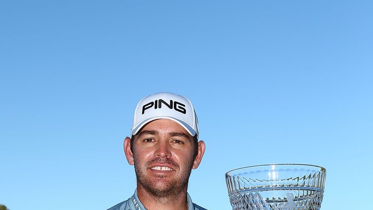 Louis Oosthuizen of South Africa poses with the trophy after winning the 2016 Perth International