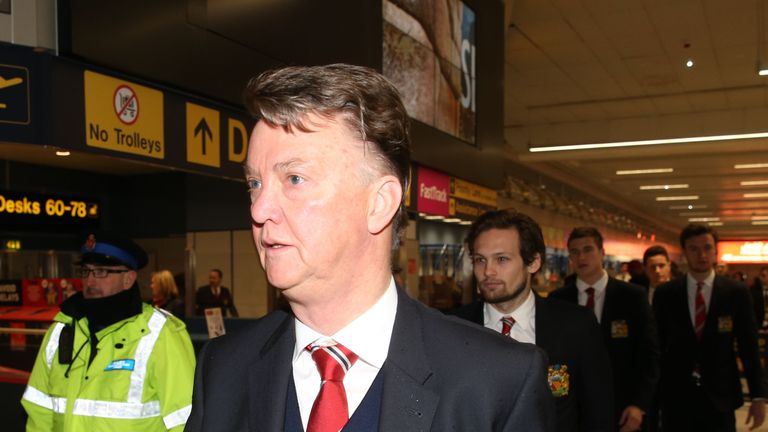 Louis van Gaal leads his Manchester United side through Manchester Airport ahead of a clash with FC Midtjylland