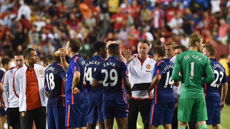 Van Gaal speaks to his players before a penalty shootout in July 2014 after a pre-season draw with Inter Milan