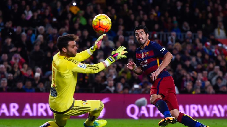 Luis Suarez of FC Barcelona scores his team's second goal past Sergio Alvarez of RC Celta de Vigo during the La Liga match