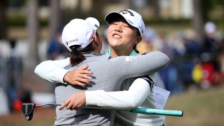 Lydia Ko of New Zealand (R) hugs Jang Ha-Na of South Korea on the 18th hole at the Coates Golf Championship