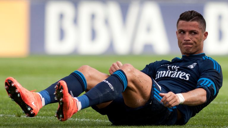 Cristiano Ronaldo sits on the field during the game with Malaga