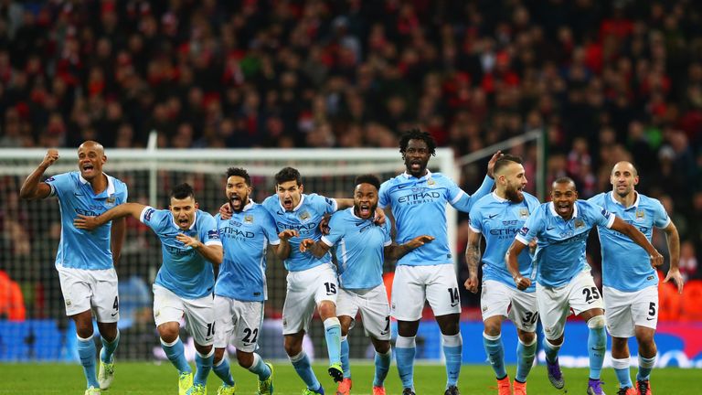 LONDON, ENGLAND - FEBRUARY 28:  Manchester City players celebrate as Yaya Toure of scores the winning penalty to win the shoot out during the Capital One C