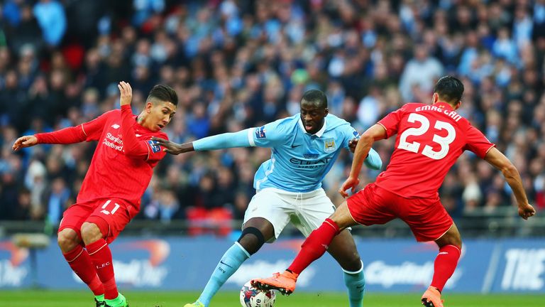 LONDON, ENGLAND - FEBRUARY 28:  Yaya Toure of Manchester City goes between Roberto Firmino (L) and Emre Can of Liverpool (R) during the Capital One Cup Fin
