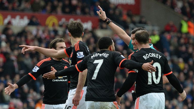 Manchester United players protest a decision at the Stadium of Light