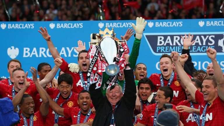 Former Manchester United boss Sir Alex Ferguson lifts the Premier League trophy