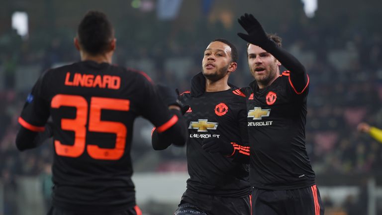 Memphis Depay (C) of Manchester United celebrates scoring his team's first goal with his team mates Jesse Lingard (L) and Juan Mata