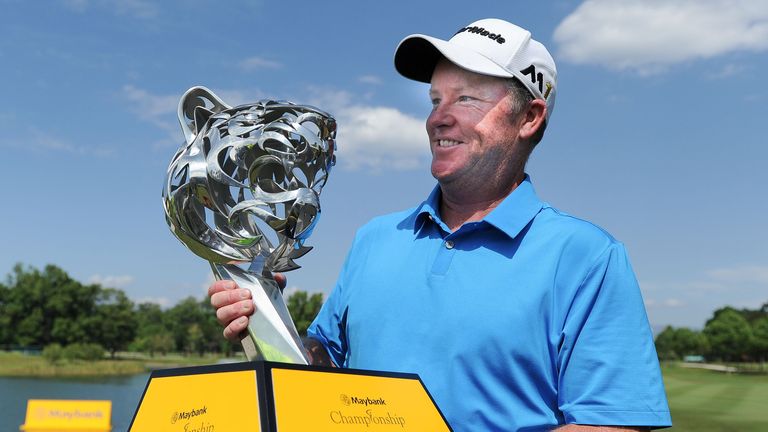 Marcus Fraser of Australia poses with the trophy after winning the 2016 Maybank Championship Malaysia
