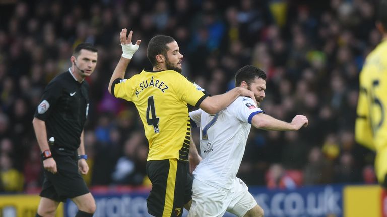 Watford midfielder Mario Suarez (L) fouls Leeds striker Mirco  Antenucci (R) during the FA cup fifth round football match between Watford and Leeds