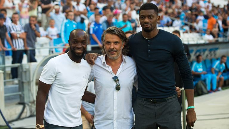 Olympique de Marseille's French president Vincent Labrune (C) poses with Lassana Diarra (L) and Abou Diaby