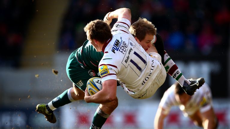 Andrew Fenby of London Irish is tackled by Mathew Tait of Leicester during the Aviva Premiership match between Leicester Tigers and London Irish