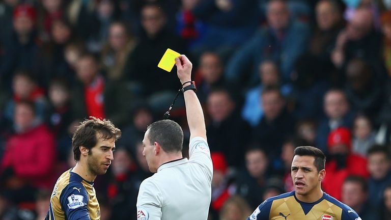 BOURNEMOUTH, ENGLAND - FEBRUARY 07:  Mathieu Flamini of Arsenal is shown a yellow card by referee Kevin Friend during the Barclays Premier League match bet