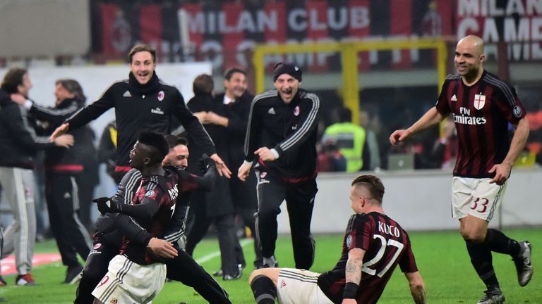 AC Milan's French forward Mbaye Niang (L) celebrates with teammates after scoring