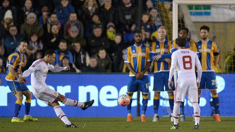 Manchester United's Dutch midfielder Memphis Depay (L) takes a free kick 