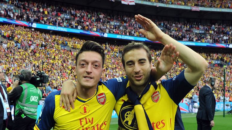 LONDON, ENGLAND - MAY 30: (L-R) Arsenal's Mesut Ozil and Mathieu Flamini celebrate after the FA Cup Final between Aston Villa and Arsenal