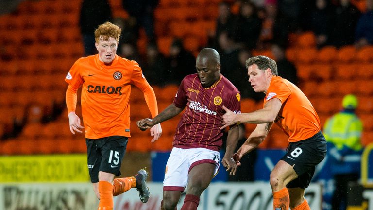 Motherwell's Morgaro Gomis (centre) is challenged by Dundee United's John Rankin