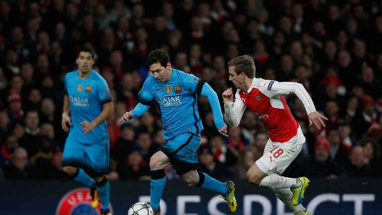 Arsenal's Nacho Monreal (R) vies with Barcelona's Lionel Messi