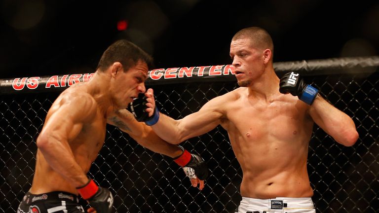 Nate Diaz (R) punches Rafael dos Anjos in their lightweight bout during the UFC Fight Night event at the at U.S. Airways Center