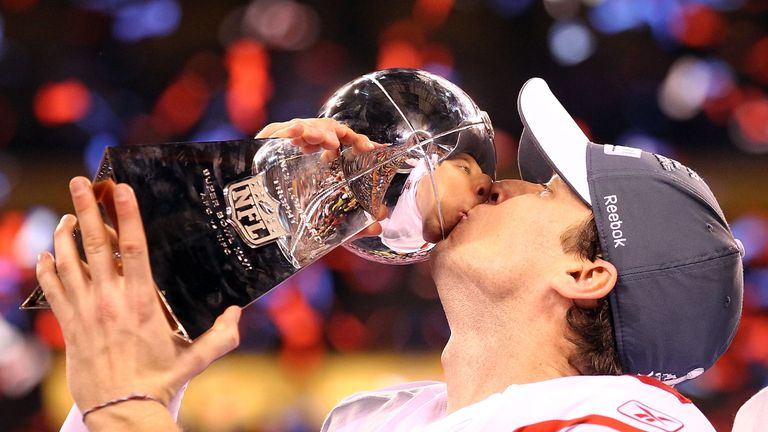 Lawrence Tynes of the New York Giants kisses the Vince Lombardi Trophy