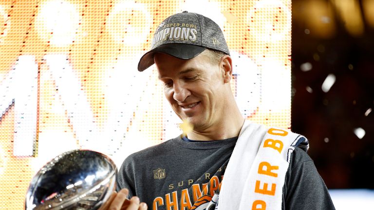 Peyton Manning of the Denver Broncos looks at the Vince Lombardi Trophy after Super Bowl 50