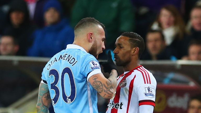 Jermain Defoe of Sunderland and Nicolas Otamendi of Manchester City square off