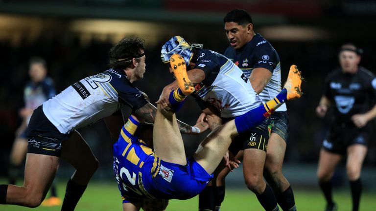 North Queensland Cowboys' Ethan Lowe (left) and Johnathan Thurston tackle Leeds Rhinos' Ash Handley during the World Club Series match at Headingley