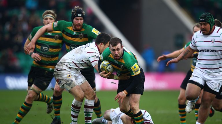 JJ Hanarahan of Northampton charges past Fergus Mulchrone of London Irish 