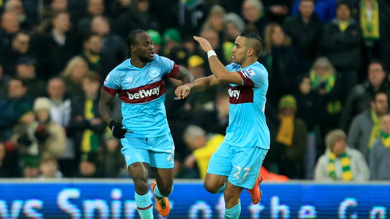 Dimitri Payet (R) of West Ham United celebrates scoring his team's first goal with his team mate Victor Moses (L) during t