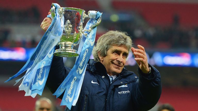 LONDON, ENGLAND - MARCH 02:  Manuel Pellegrini, manager of Manchester City celebrates victory with the trophy after the Capital One Cup Final between Manch