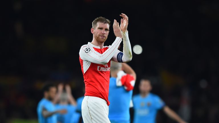 LONDON, ENGLAND - FEBRUARY 23:  A dejected Per Mertesacker of Arsenal applauds the home fans following their team's 2-0 defeat during the UEFA Champions Le
