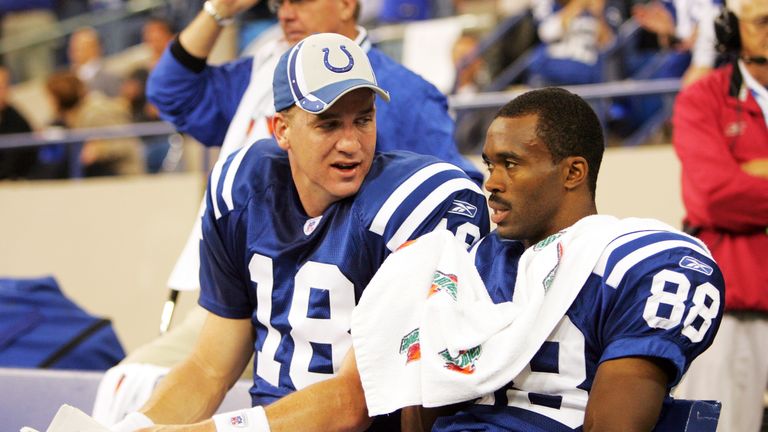 Peyton Manning #18 and Marvin Harrison #88 of the Indianapolis Colts talk on the bench after a touchdown against the St. Louis 