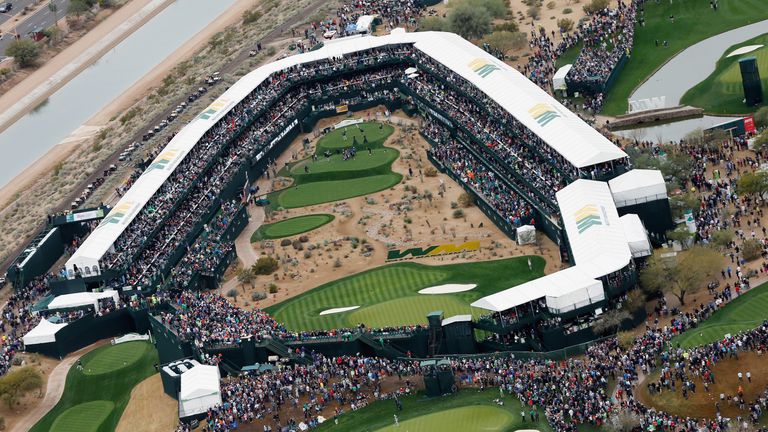 A large group of fans watch the play around the par-three 16th hole during the third round of the Waste Management Phoenix Op