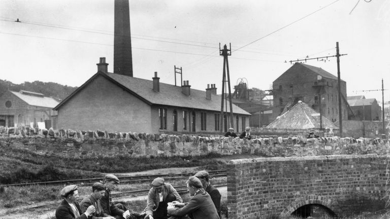May 1926:  A group of miners passing the time with a game of cards outside Prestonpans Colliery, East Lothian, during industrial action at the time of the 