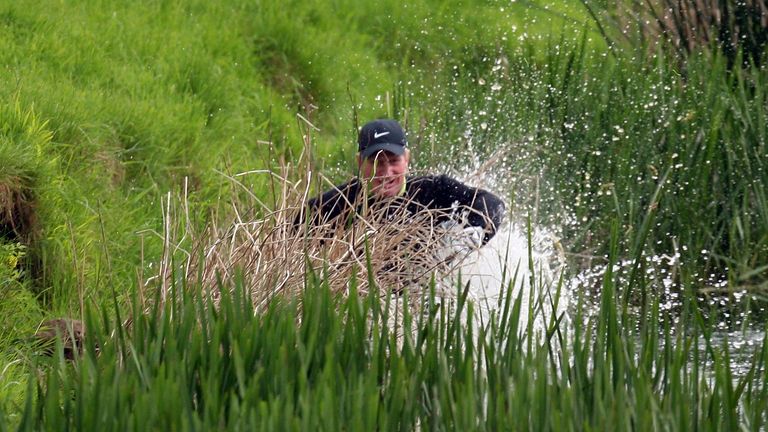 Richard Finch of England falls into the river Maigue after his second shot to the par five 18th hole during the final round