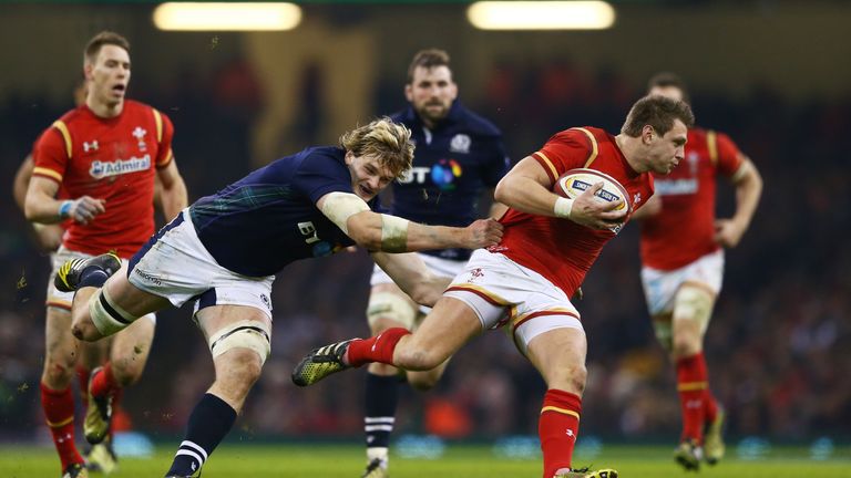 Dan Biggar of Wales escapes the tackle from Richie Gray of Scotland in Cardiff