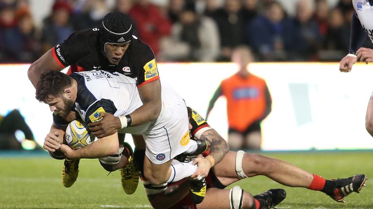 Rob Webber of Bath is tackled by Maro Itoje and Jim Hamilton during the Aviva Premiership match between Saracens and Bath