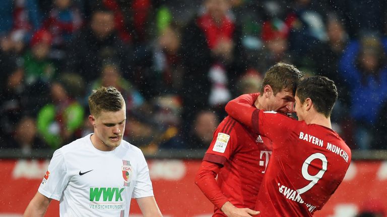 Robert Lewandowski (far right) celebrates his first goal with Thomas Muller