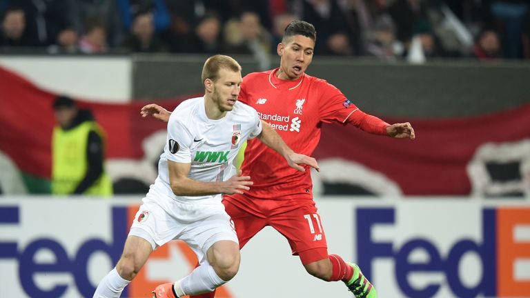 Ragnar Klavan of Augsburg and Roberto Firmino of Liverpool compete for the ball during the UEFA Europa League round of 32 first leg match 