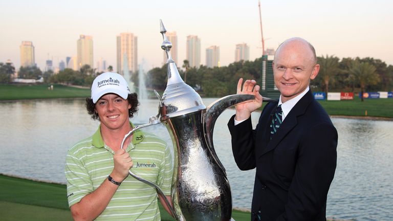 DUBAI, UNITED ARAB EMIRATES - FEBRUARY 01:  Rory McIlroy of Northern Ireland poses with the trophy and the tournament director from Golf in Dubai Adrian Fl